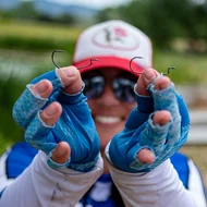 Side-by-side photo of two fish hooks on a plain background: one hook with a more traditional round bend and the other with a noticeably larger, extra-wide gap between the shank and the hook point, illustrating the difference in shape and spacing between the two styles used for rigging soft plastic baits in fishing.